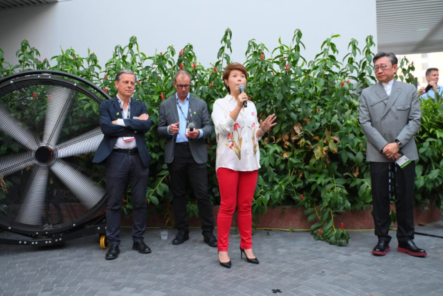Sharon Teo, Managing Director, Workspace Management, Retail & Workspace, CapitaLand Investment, CapitaLand Group, delivers remarks to the gathered crowd at the amphitheater atop CapitaSpring, the host venue of the Opening Networking Reception.