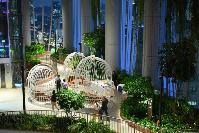 The Opening Networking Reception extended across multiple spaces at CapitaSpring, including the Green Oasis, a multi-story skygarden traversed by a meandering ramp.